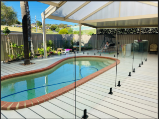 Decking with a pool in the middle and covered by a gable structure