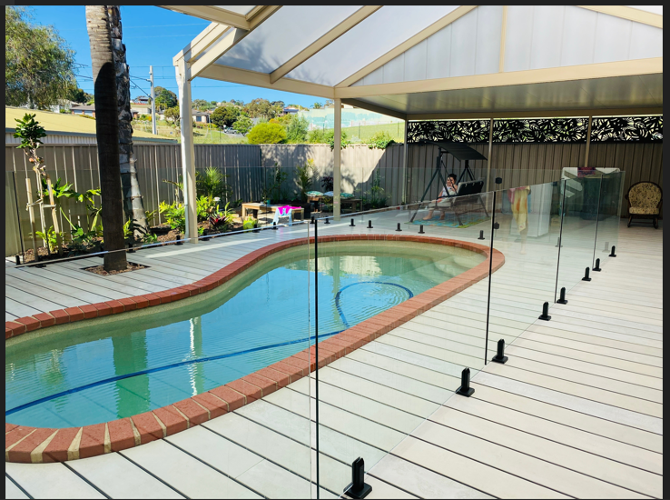 Decking with a pool in the middle and covered by a gable structure